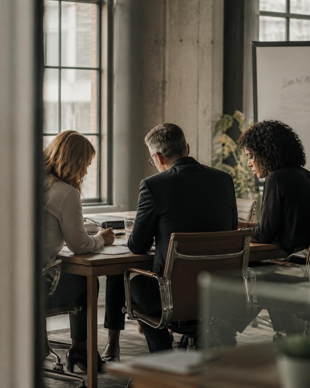 An executive team working through decisions around a table